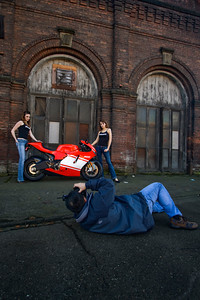 Ducati Desmosedici motorcycle shoot.  With Katie and Krista next to the Desmosedici, I tried to show a contrast between the sexy smooth curves of the bike vs. a gritty dirty building in Georgetown. http://www.jaytphotos.com/gallery/7132826_ssxuu#458192415_P9pWn